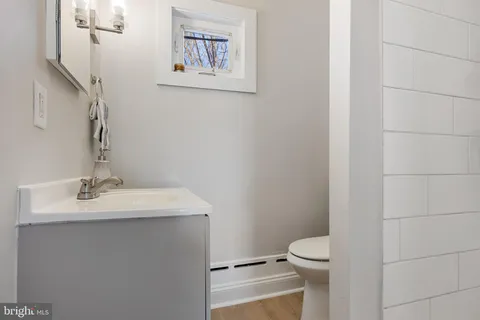 a bathroom with a toilet sink and mirror