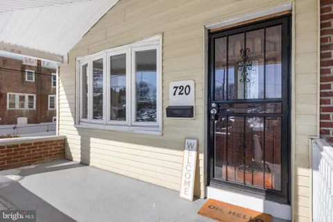 a front view of a house with a glass windows and door
