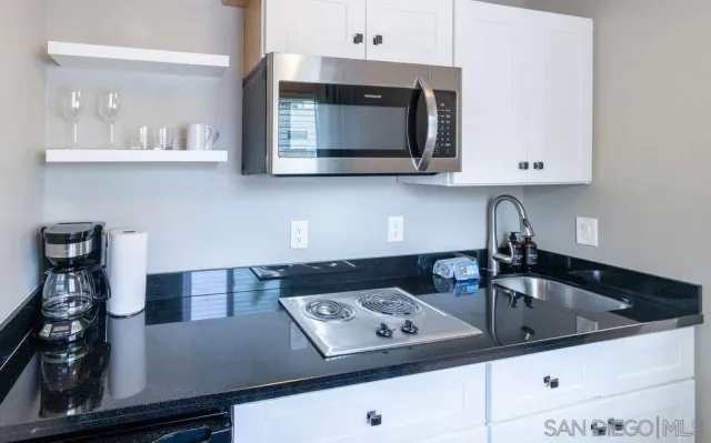 a kitchen with a sink and cabinets