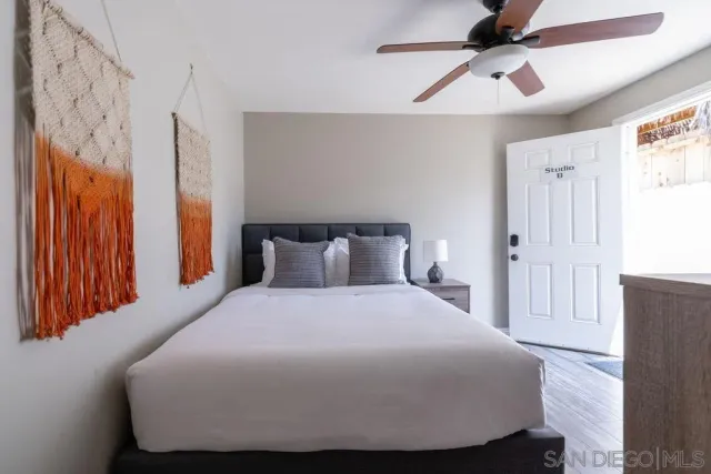 a bedroom with a bed and a chandelier