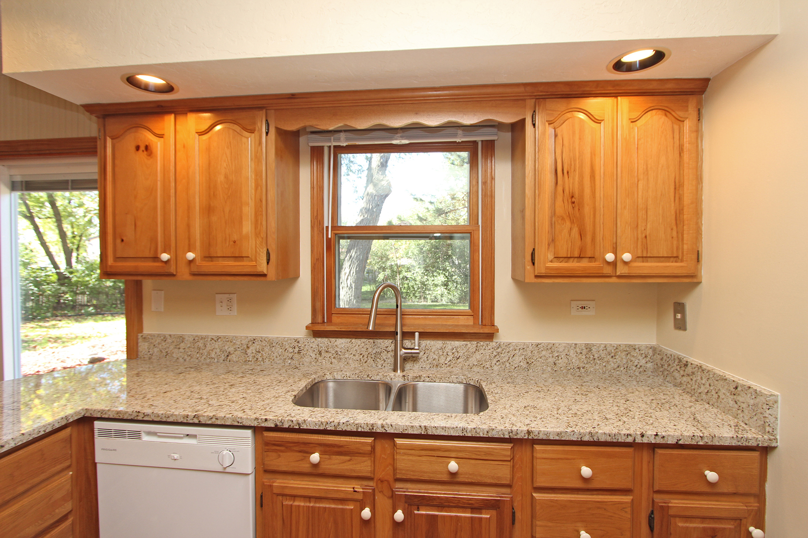 65 Old Mill Grove Road Lake Zurich, IL 60047 - Photo 11 of 29 a kitchen with granite countertop a sink a window and cabinets