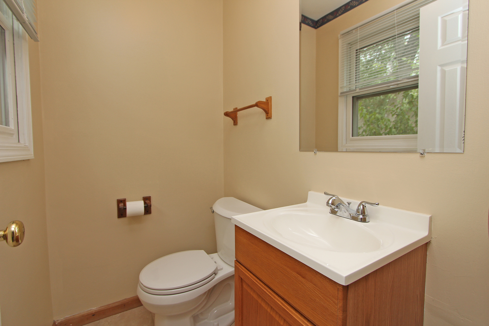 65 Old Mill Grove Road Lake Zurich, IL 60047 - Photo 19 of 29 a bathroom with a sink a toilet and a window