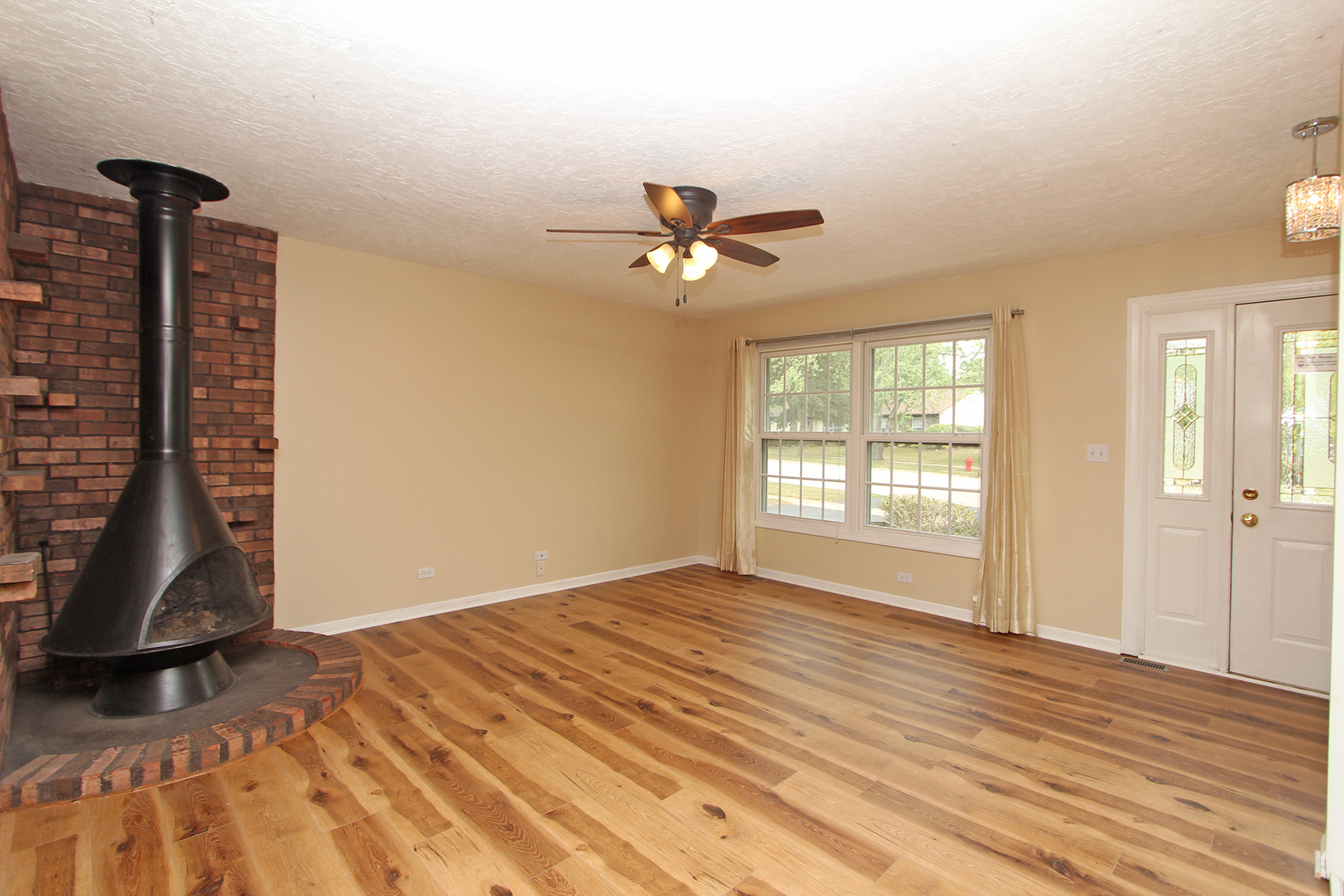 65 Old Mill Grove Road Lake Zurich, IL 60047 - Photo 3 of 29 a view of room with ceiling fan and wooden floor