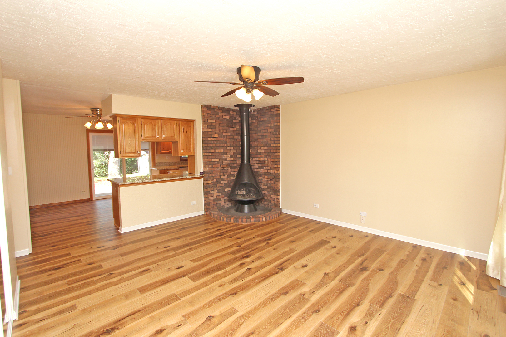 65 Old Mill Grove Road Lake Zurich, IL 60047 - Photo 5 of 29 a view of a living room with kitchen island stainless steel appliances wooden floor and view living room