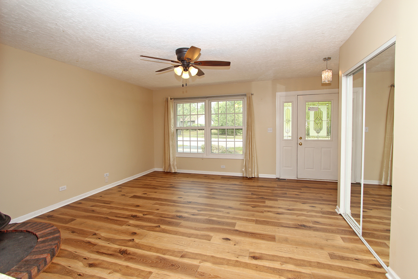 65 Old Mill Grove Road Lake Zurich, IL 60047 - Photo 6 of 29 a view of empty room with wooden floor and fan