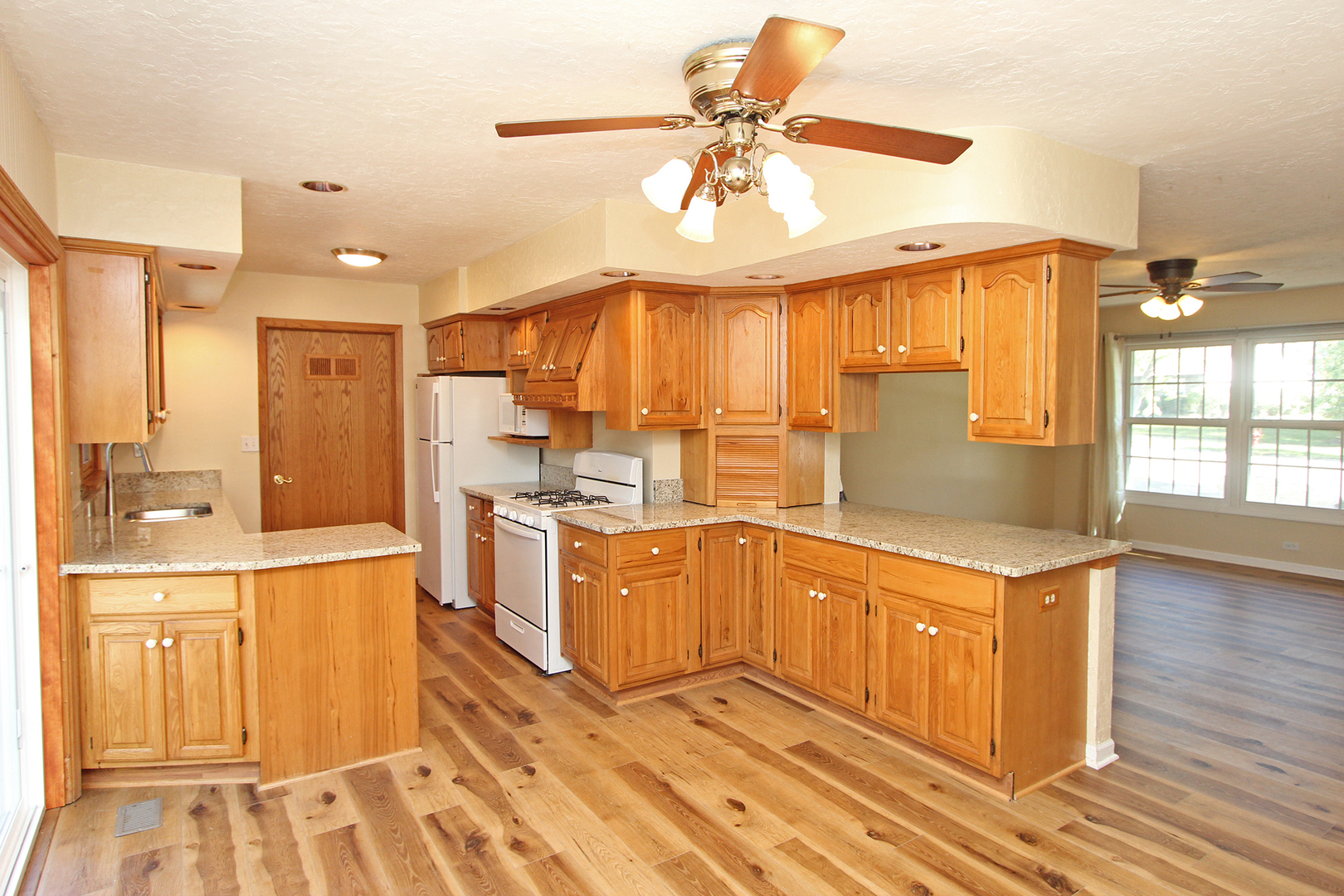 65 Old Mill Grove Road Lake Zurich, IL 60047 - Photo 7 of 29 a kitchen with a stove a sink and a refrigerator