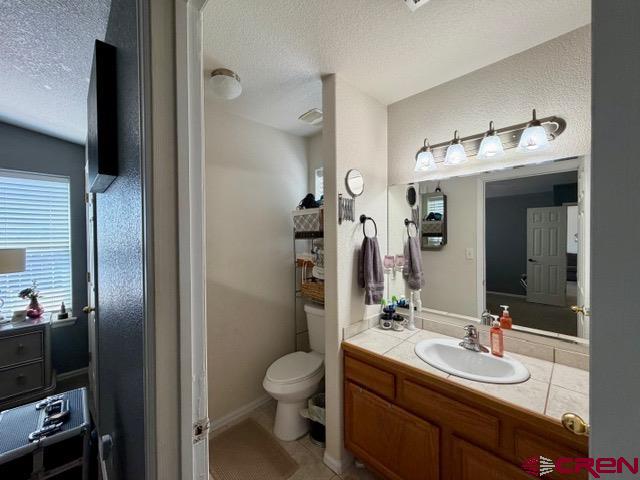 544 20th Street Delta, CO 81416 - Photo 21 of 44 a bathroom with a toilet sink and mirror