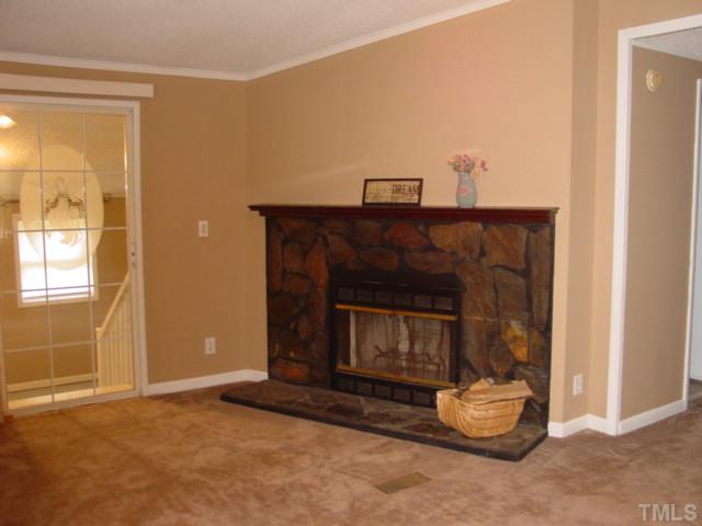 8116 Bacon Road Timberlake, NC 27583 - Photo 2 of 15 Large living room with wood burning fireplace...great bonus space off of this room as well.