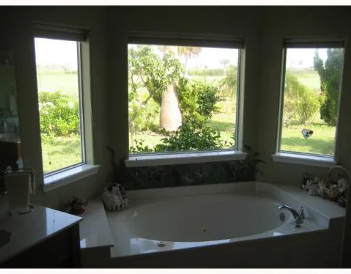 a bath tub sitting in a bathroom next to a window