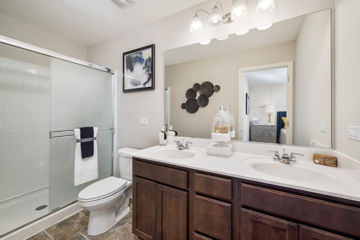3728 Bailey Road Yorkville, IL 60560 - Photo 15 of 16 a bathroom with a toilet a sink a mirror and a shower