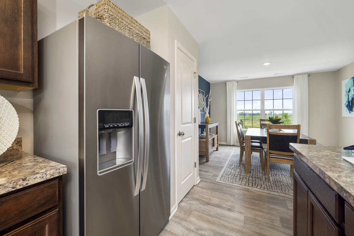 3728 Bailey Road Yorkville, IL 60560 - Photo 5 of 16 a kitchen with granite countertop kitchen island wooden cabinets and stainless steel appliances