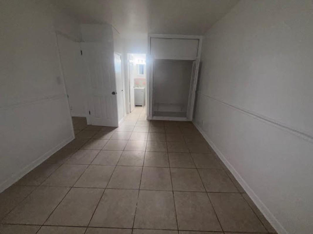 6008 Northwest 10th Street, Unit 3 Pompano Beach, FL 33063 - Photo 6 of 8 an empty room with a bathroom