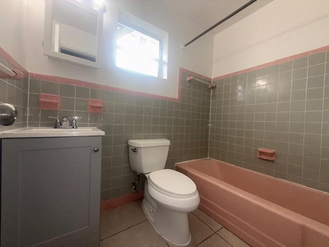 6008 Northwest 10th Street, Unit 3 Pompano Beach, FL 33063 - Photo 7 of 8 a bathroom with a sink a toilet and shower