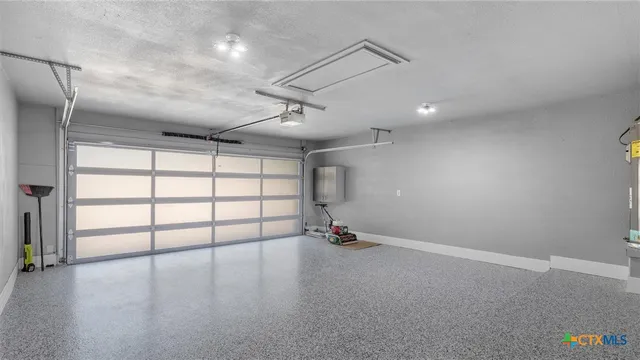 an empty room with windows and ceiling fan