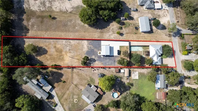an aerial view of a house with garden space and lake view