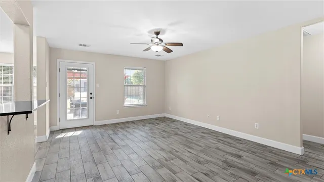 wooden floor in an empty room with a window