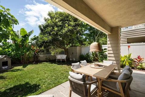 a view of a patio with a table chairs and a backyard