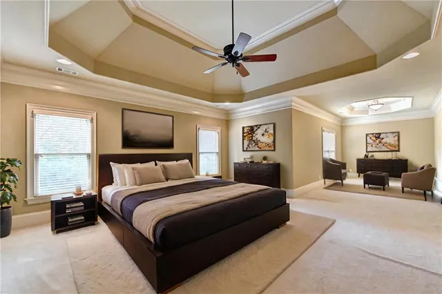 a bedroom with a large bed and a chandelier