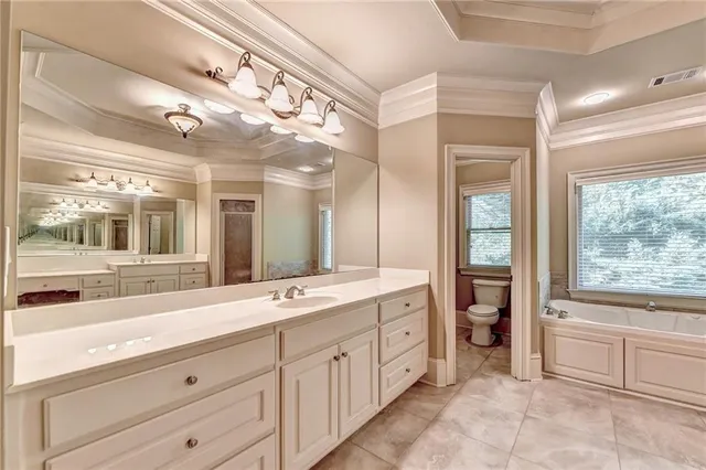 a spacious bathroom with a double vanity sink mirror and double