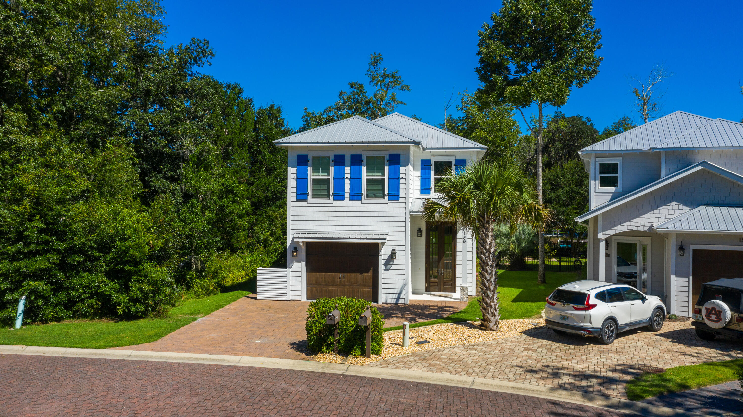 a front view of a house with a garden