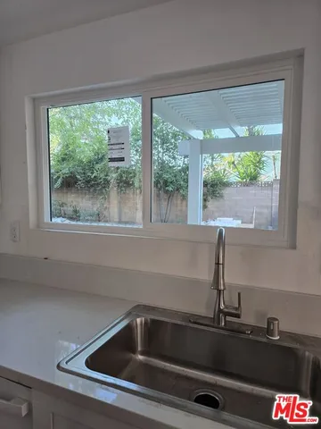 a kitchen sink with a next to window