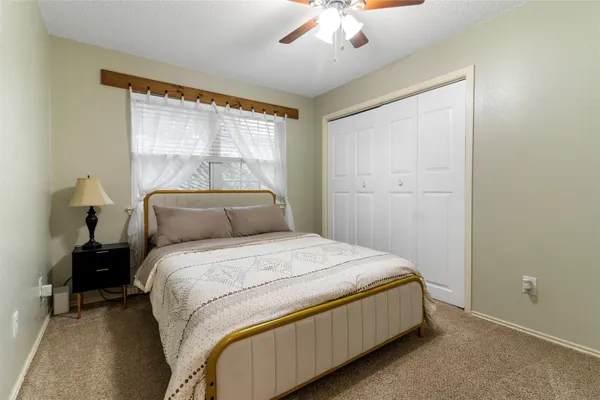 a bedroom with a bed and window