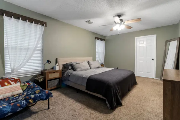 a bedroom with bed and window