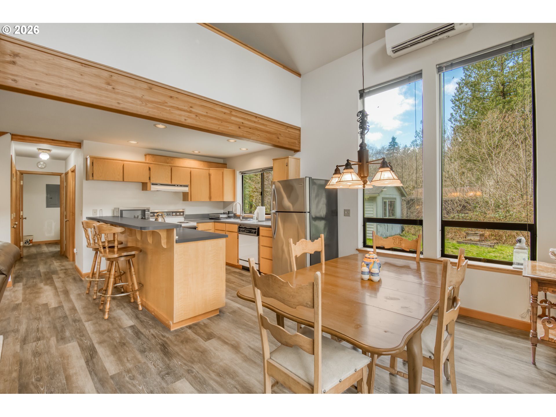 78488 Highway 53 Nehalem, OR 97131 - Photo 11 of 40 a dining hall with stainless steel appliances a dining table and chairs with floor to ceiling window