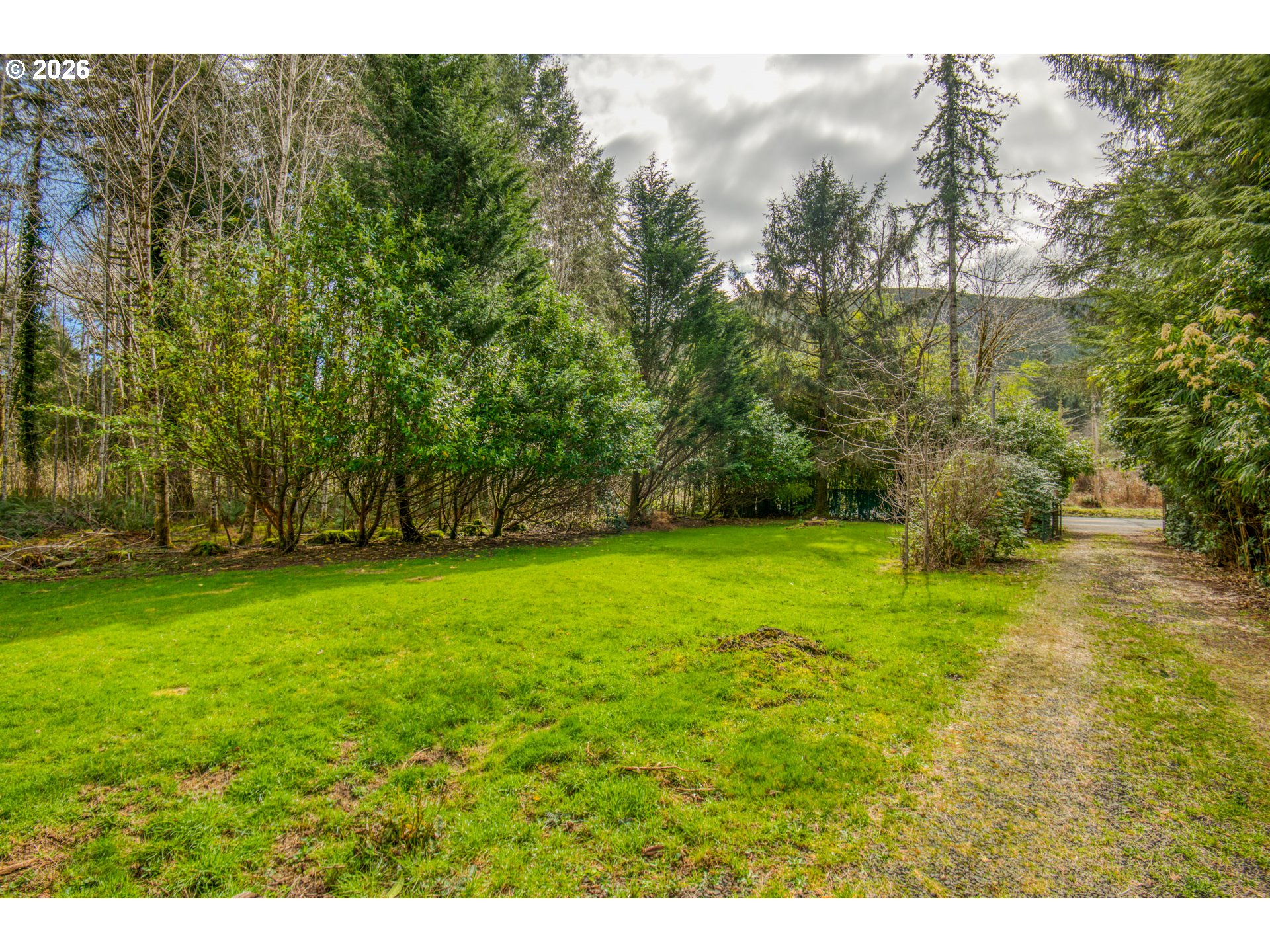 78488 Highway 53 Nehalem, OR 97131 - Photo 40 of 40 a backyard of a house with lots of green space