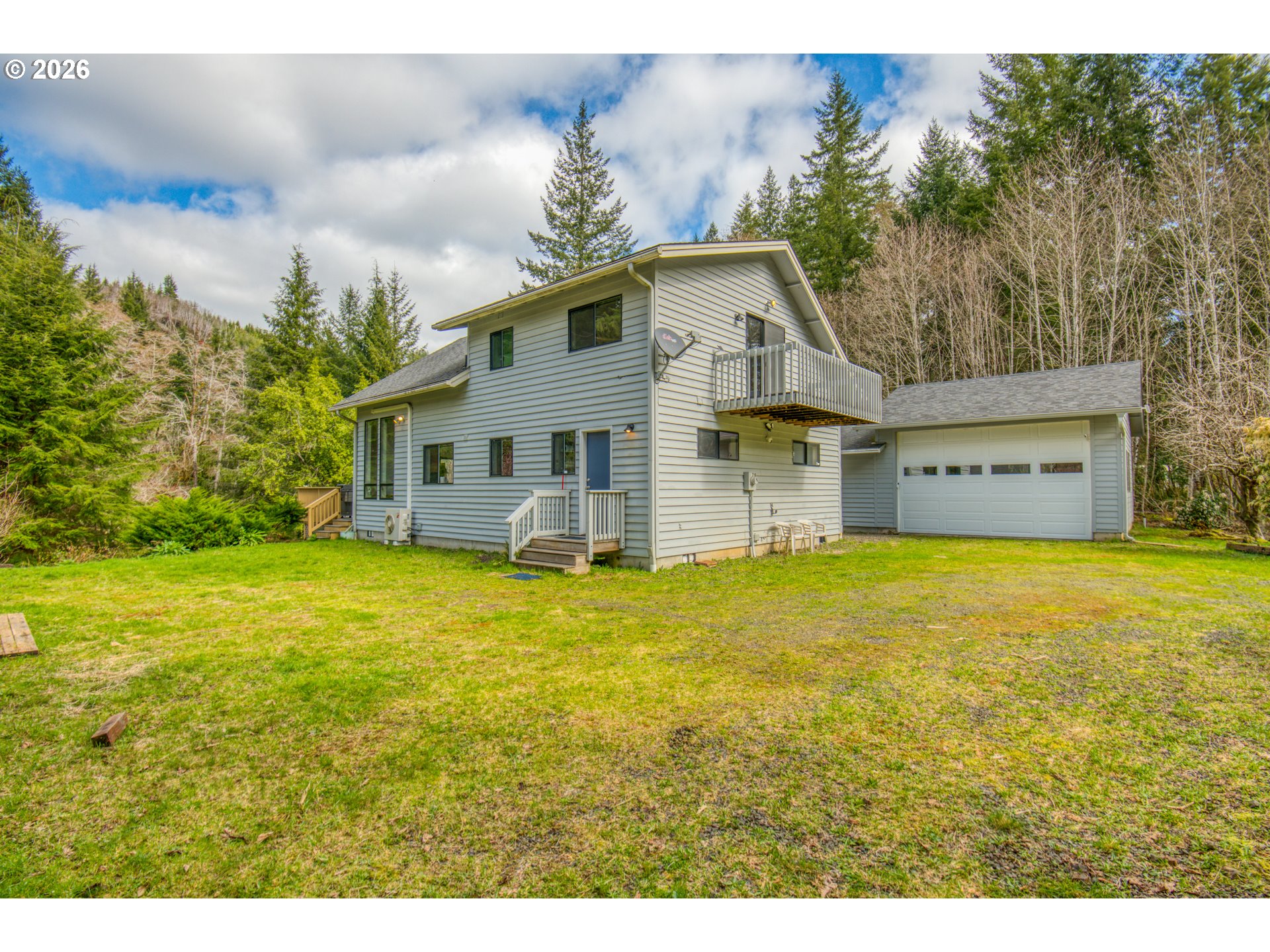 78488 Highway 53 Nehalem, OR 97131 - Photo 5 of 40 a view of a house with backyard and garden