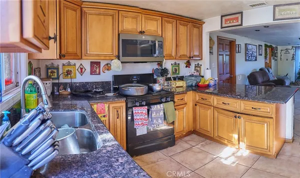 a kitchen with stainless steel appliances a stove a sink and a microwave