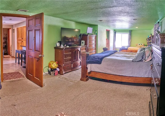 a bedroom with furniture and a large window