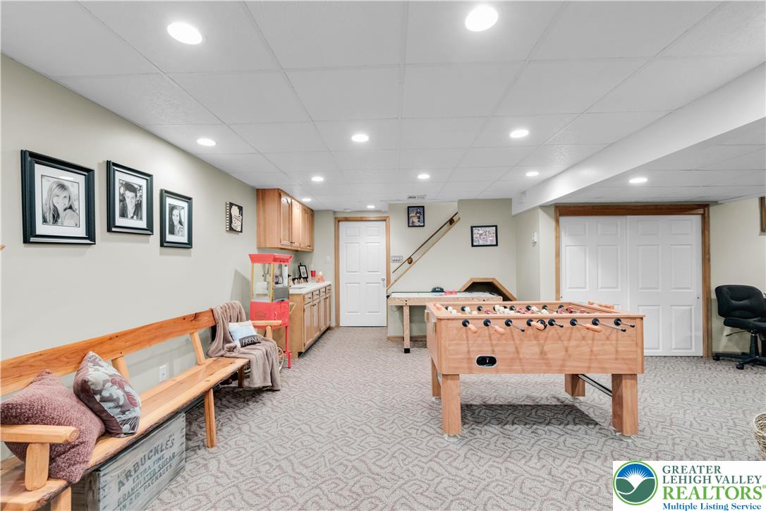 4059 Old Sentry Road Allentown, PA 18104 - Photo 29 of 39 A versatile recreation room boasts plush patterned carpeting and ample recessed lighting, creating a perfect entertainment space.