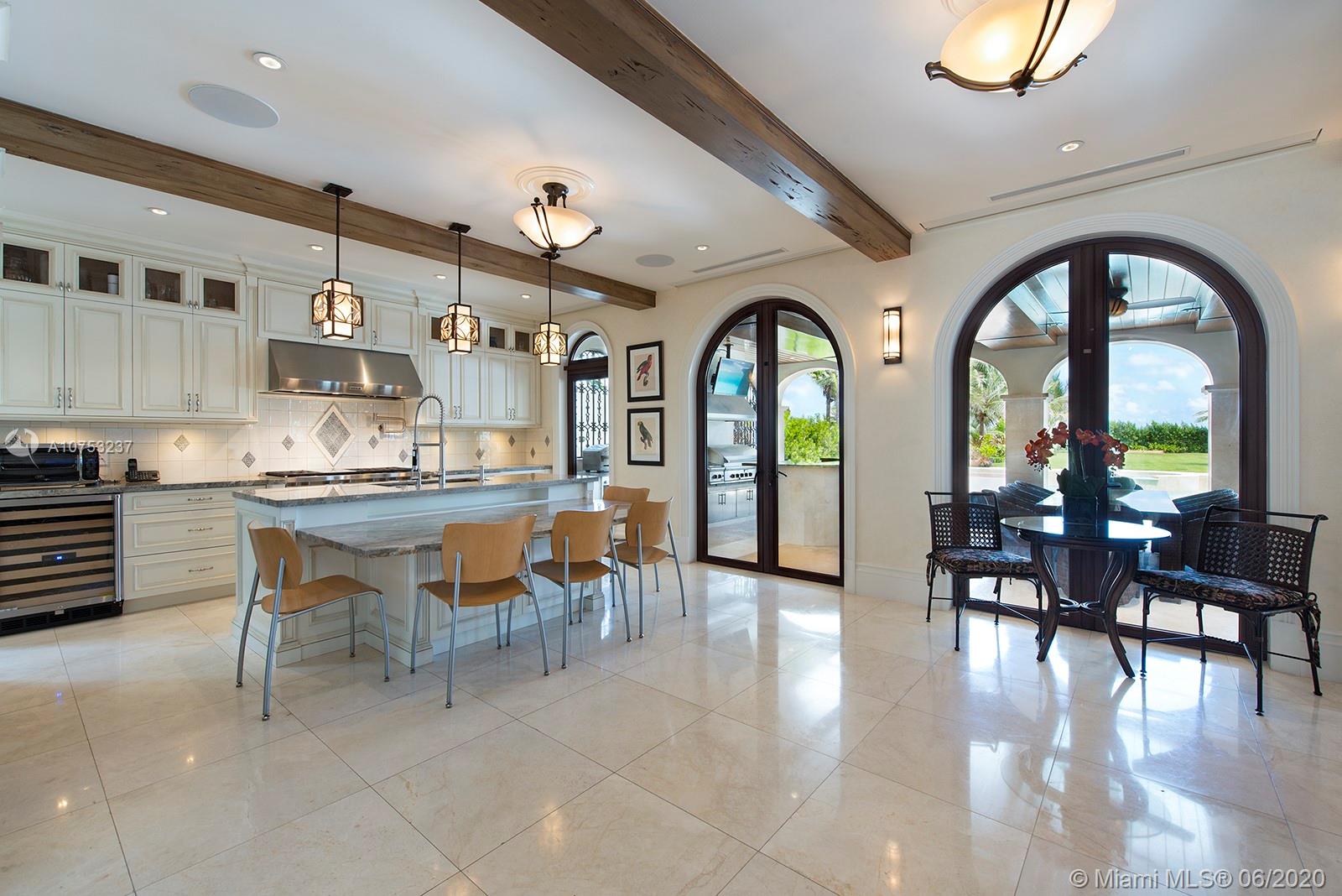 7825 Atlantic Way Miami Beach, FL 33141 - Photo 11 of 38 a living room with fireplace furniture and a large window
