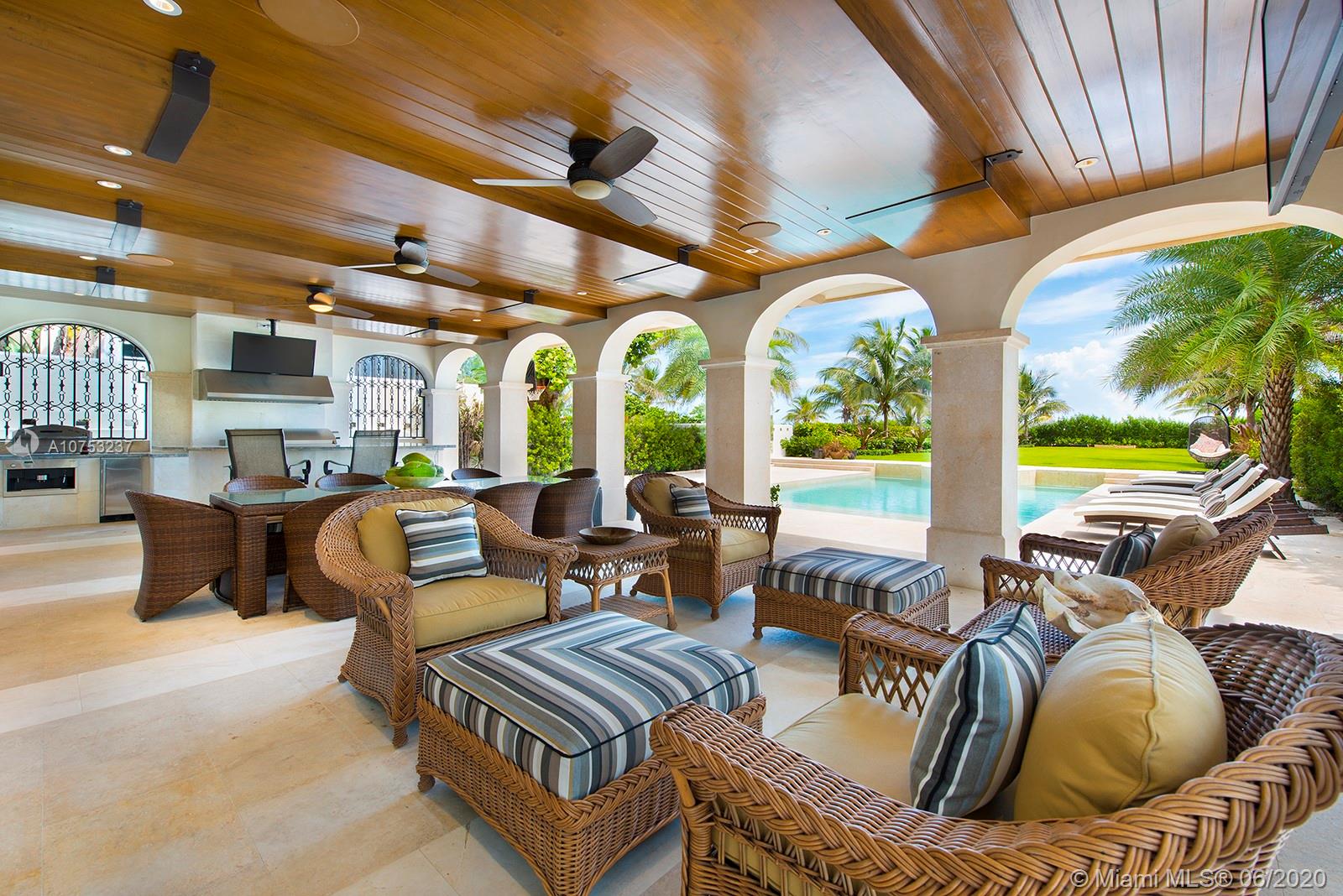 7825 Atlantic Way Miami Beach, FL 33141 - Photo 14 of 38 a living room with furniture fireplace and large windows