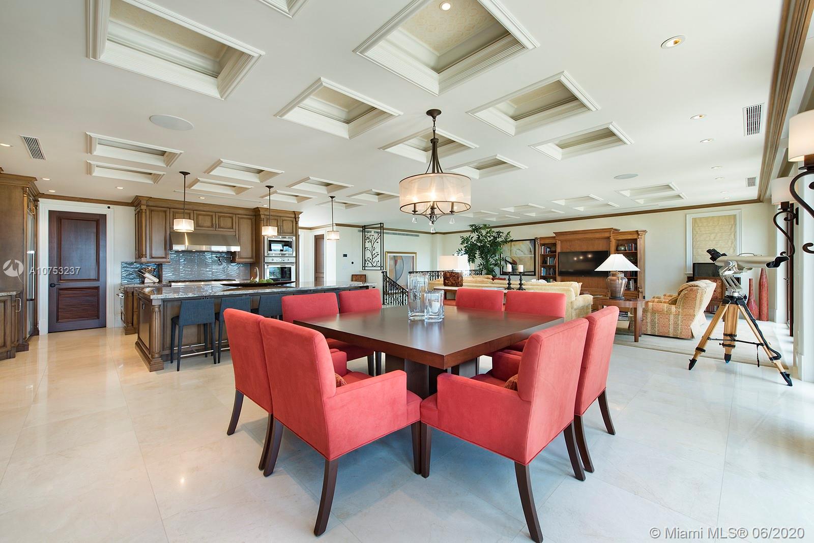 7825 Atlantic Way Miami Beach, FL 33141 - Photo 20 of 38 a dining area with a table chairs and a kitchen view
