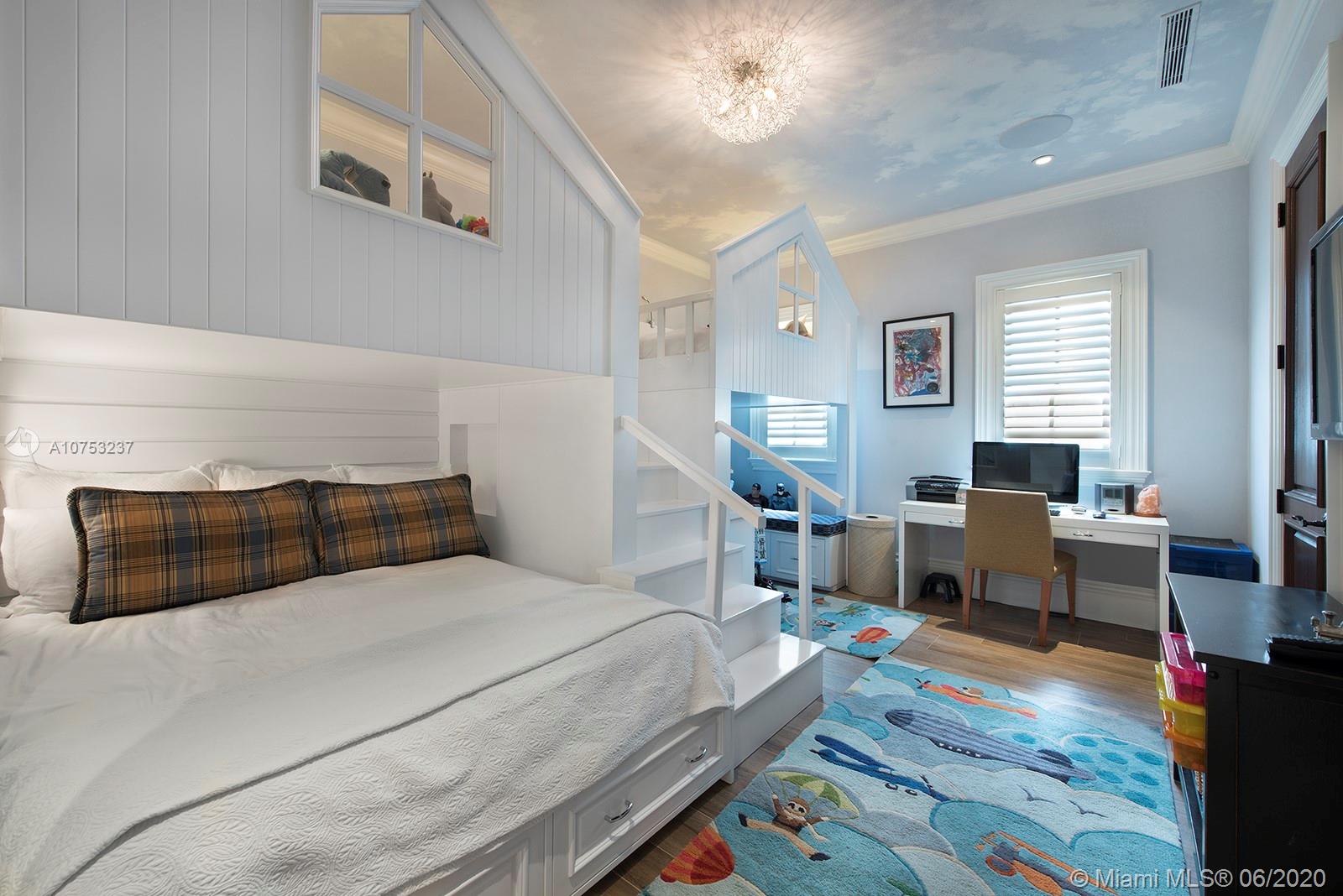 7825 Atlantic Way Miami Beach, FL 33141 - Photo 23 of 38 a bedroom with a bed a table and chair