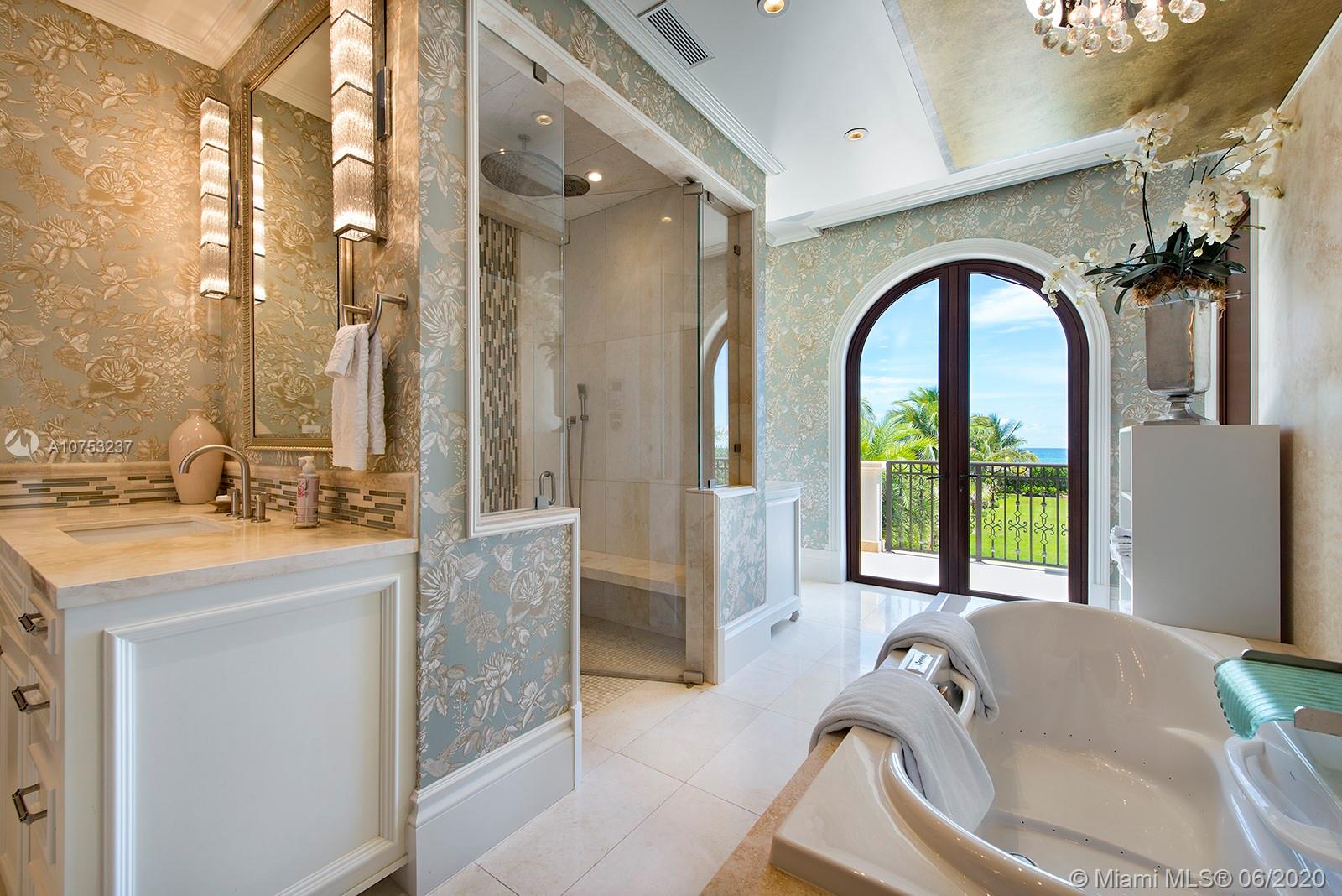 7825 Atlantic Way Miami Beach, FL 33141 - Photo 25 of 38 a bathroom with a tub sink and mirror