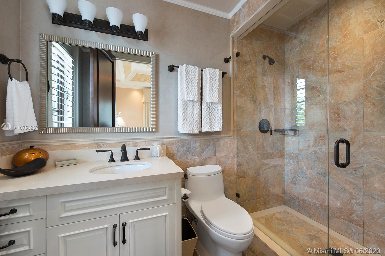 7825 Atlantic Way Miami Beach, FL 33141 - Photo 30 of 38 a bathroom with a sink a toilet and shower