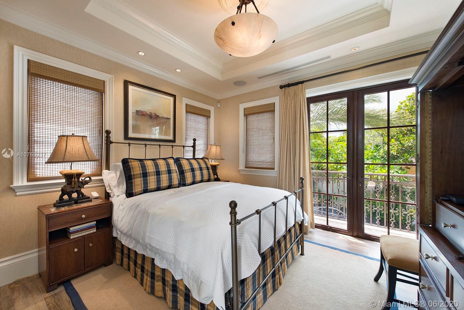 7825 Atlantic Way Miami Beach, FL 33141 - Photo 31 of 38 a bed room with a bed and a chandelier