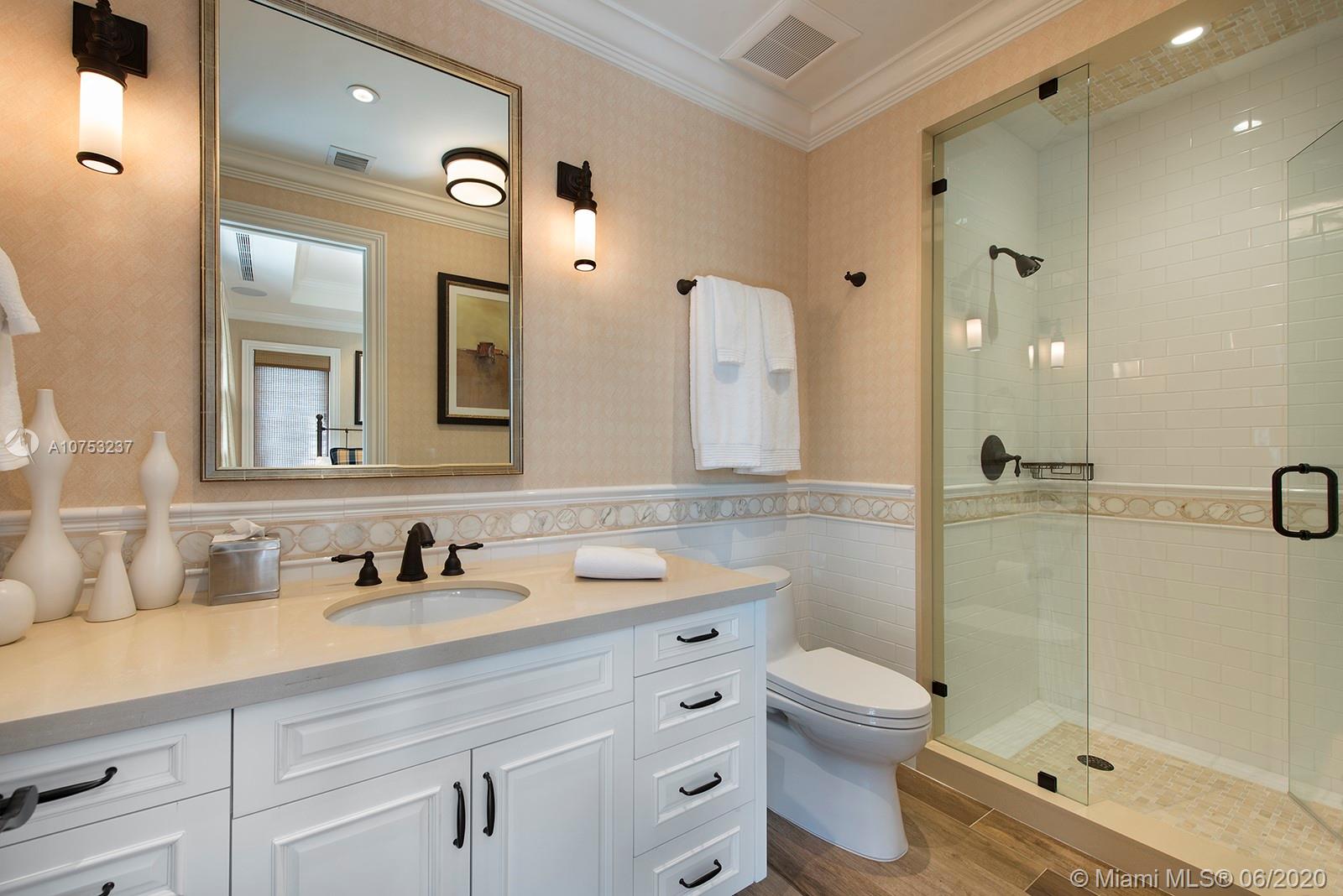 7825 Atlantic Way Miami Beach, FL 33141 - Photo 32 of 38 a bathroom with a sink a toilet and shower