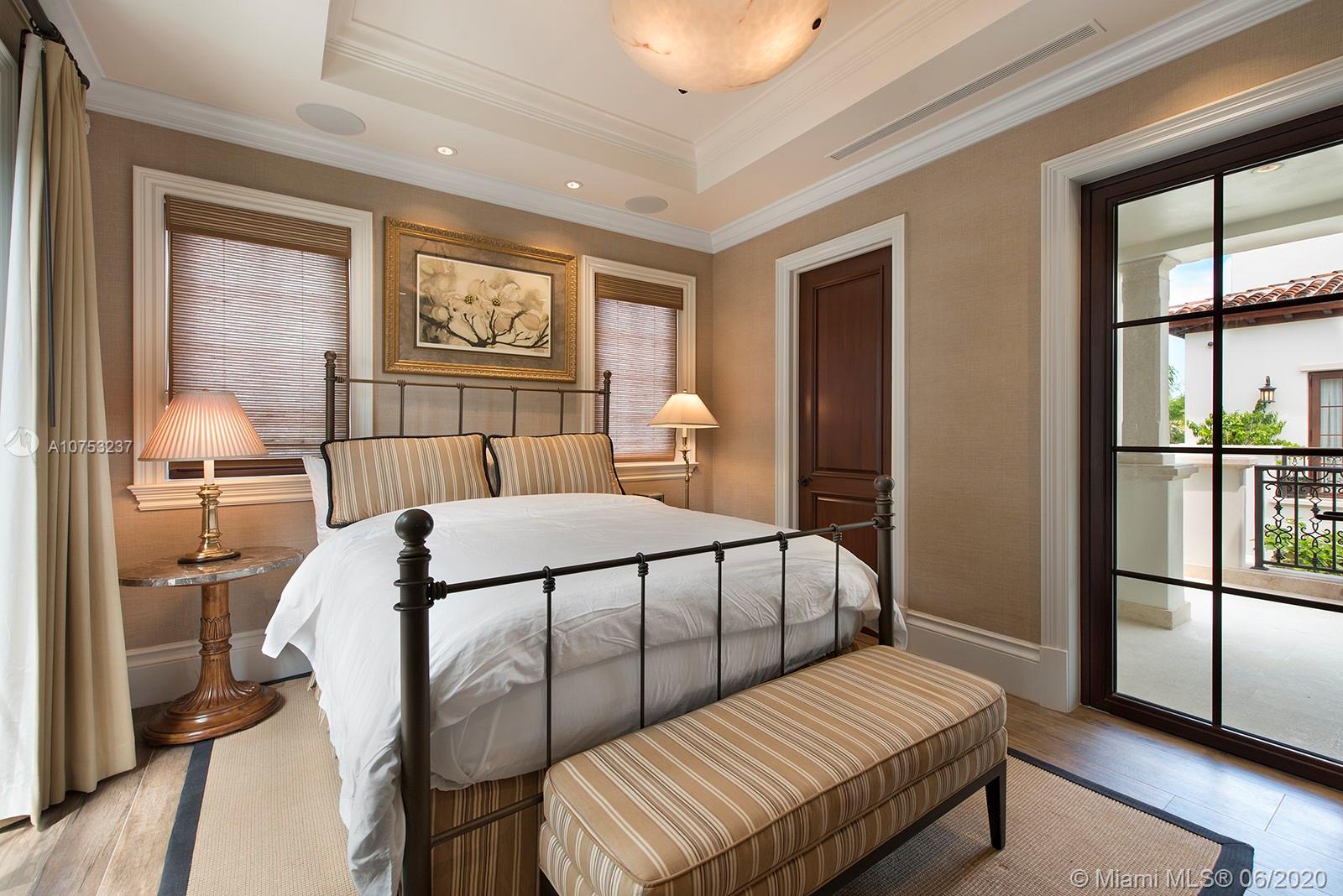 7825 Atlantic Way Miami Beach, FL 33141 - Photo 33 of 38 a bedroom with a bed and wooden floor