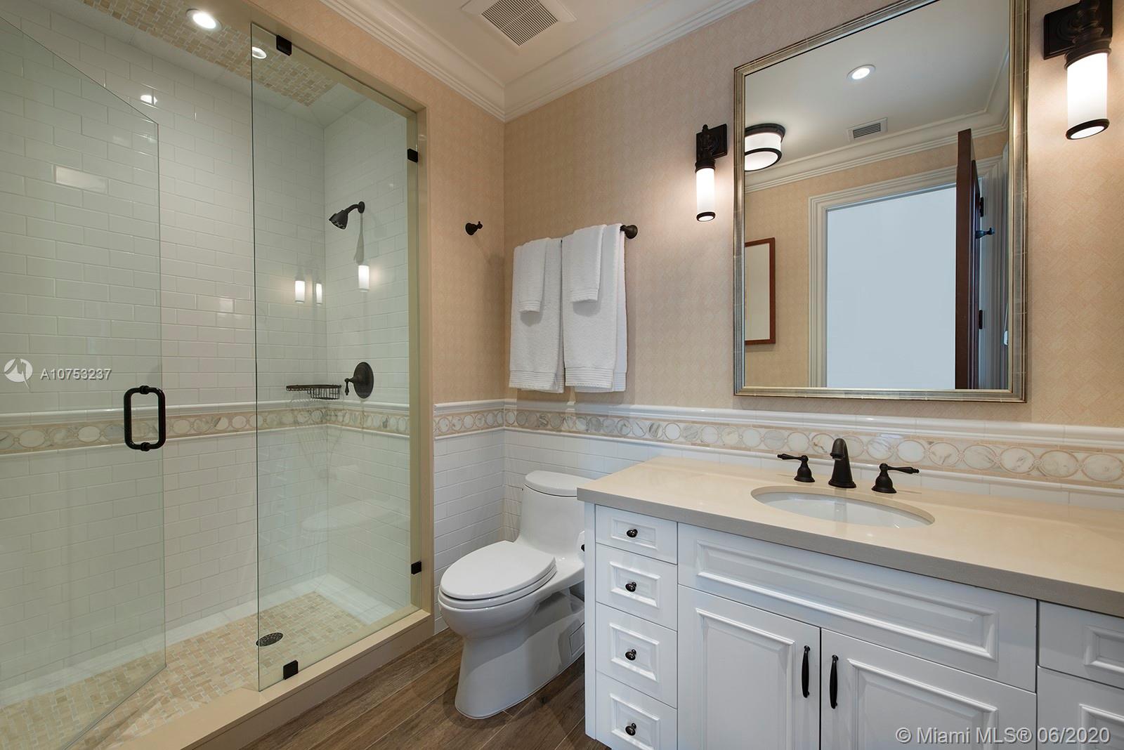 7825 Atlantic Way Miami Beach, FL 33141 - Photo 34 of 38 a bathroom with a sink a toilet and shower