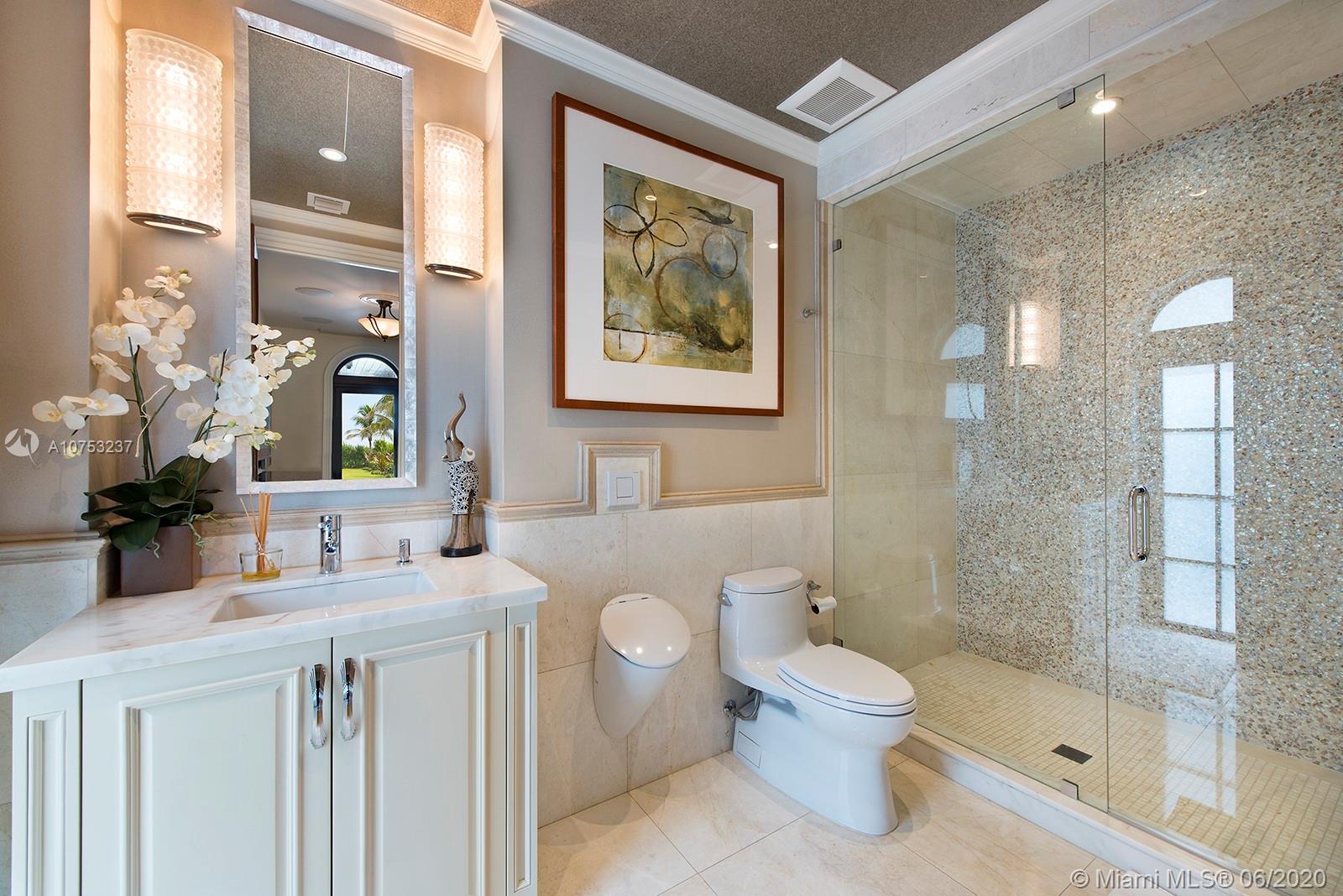 7825 Atlantic Way Miami Beach, FL 33141 - Photo 36 of 38 a bathroom with a sink a toilet and shower