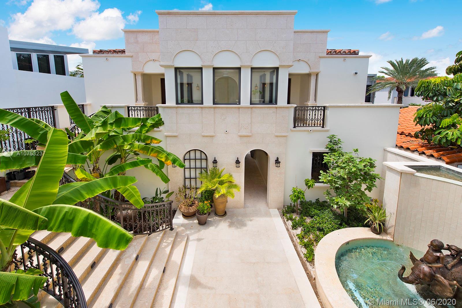 7825 Atlantic Way Miami Beach, FL 33141 - Photo 8 of 38 a front view of a house with a yard