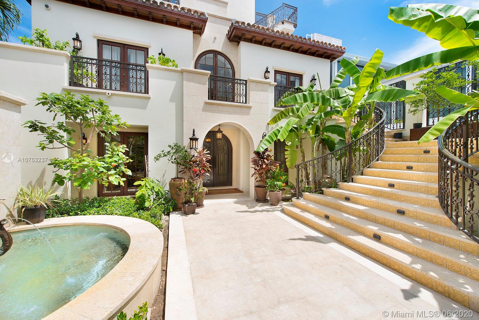 7825 Atlantic Way Miami Beach, FL 33141 - Photo 9 of 38 a front view of a house with a garden