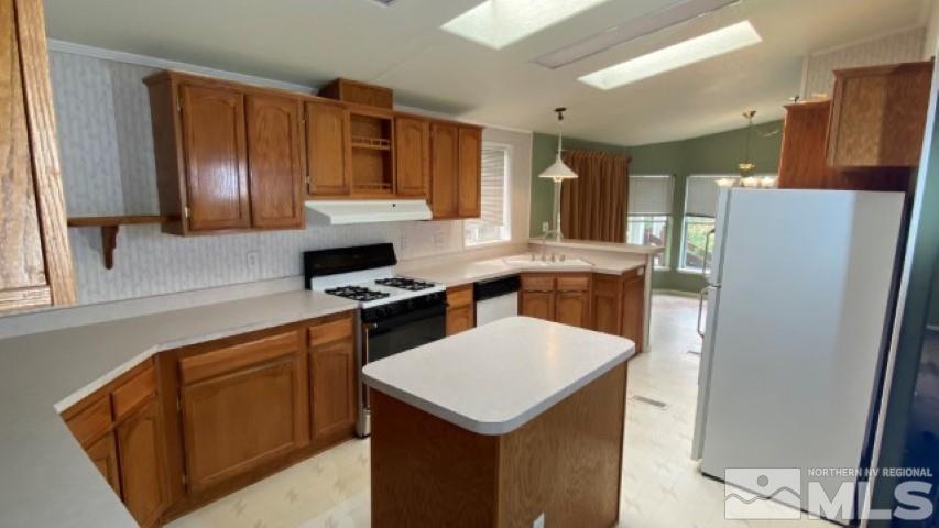 110 Taurus Circle Reno, NV 89521 - Photo 7 of 15 a kitchen with stainless steel appliances a sink a stove a refrigerator cabinets and a window