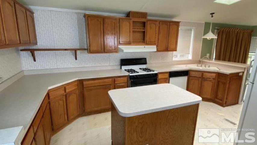 110 Taurus Circle Reno, NV 89521 - Photo 8 of 15 a kitchen with a sink a stove and a refrigerator