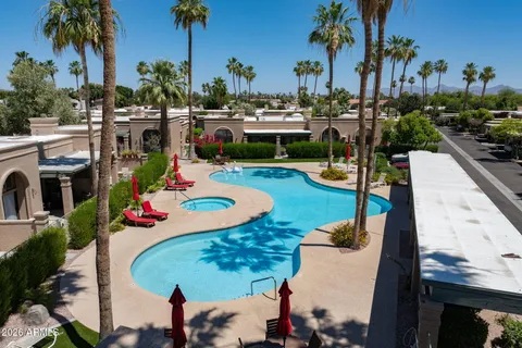 a view of a swimming pool and lounge chair