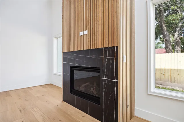a view of an empty room with a fireplace and a window